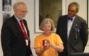 Chief Judge Robert Bell  (right) and Dr. Papenfuse (left) present Pat Melville with commissioned replica of 1632 Cecil Calvert Medal: Photo by Rob Schoeberlein 