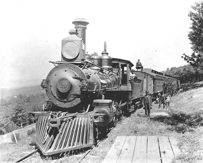 Crew standing next to a steam locomotive, 1916 circa