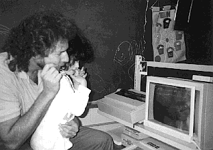 Photo: R.J. Cooper and a child work at an Apple II computer with a touchscreen