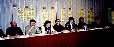 Photo of seven representatives at a long table
