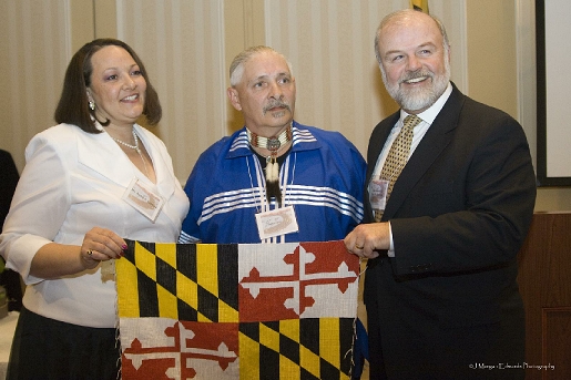 Bearclaw, artist of the Cherokee Nation from Harford County (center), presents his beaded Maryland flag to Chair Auriel A. Fenwick of the Maryland Commission on Indian Affairs (right) and to Maryland Secretary of State John P. McDonough (left) on November 28, 2008 in celebration of the State's establishment of American Indian Heritage Day.
