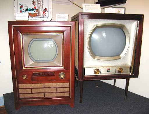 Photograph of two old televisions.