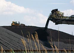 [photo, Caterpillar bulldozer & conveyor belt dumping coal, Conrail coal yard, Baltimore, Maryland]