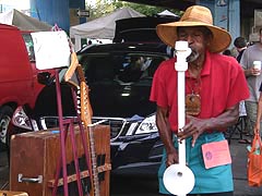 [photo, Street musician, Baltimore Farmers' Market, near Holliday St., Baltimore, Maryland]