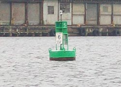 [photo, Green-lighted buoy, marking port (left) side of Baltimore Harbor channel for incoming vessels, Baltimore, Maryland]