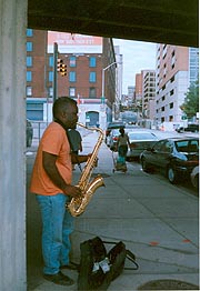 [photo, Street musician (saxophonist), East Pleasant St near Fallsway, Baltimore, Maryland]