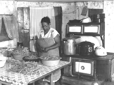 woman prepares string beans for canning